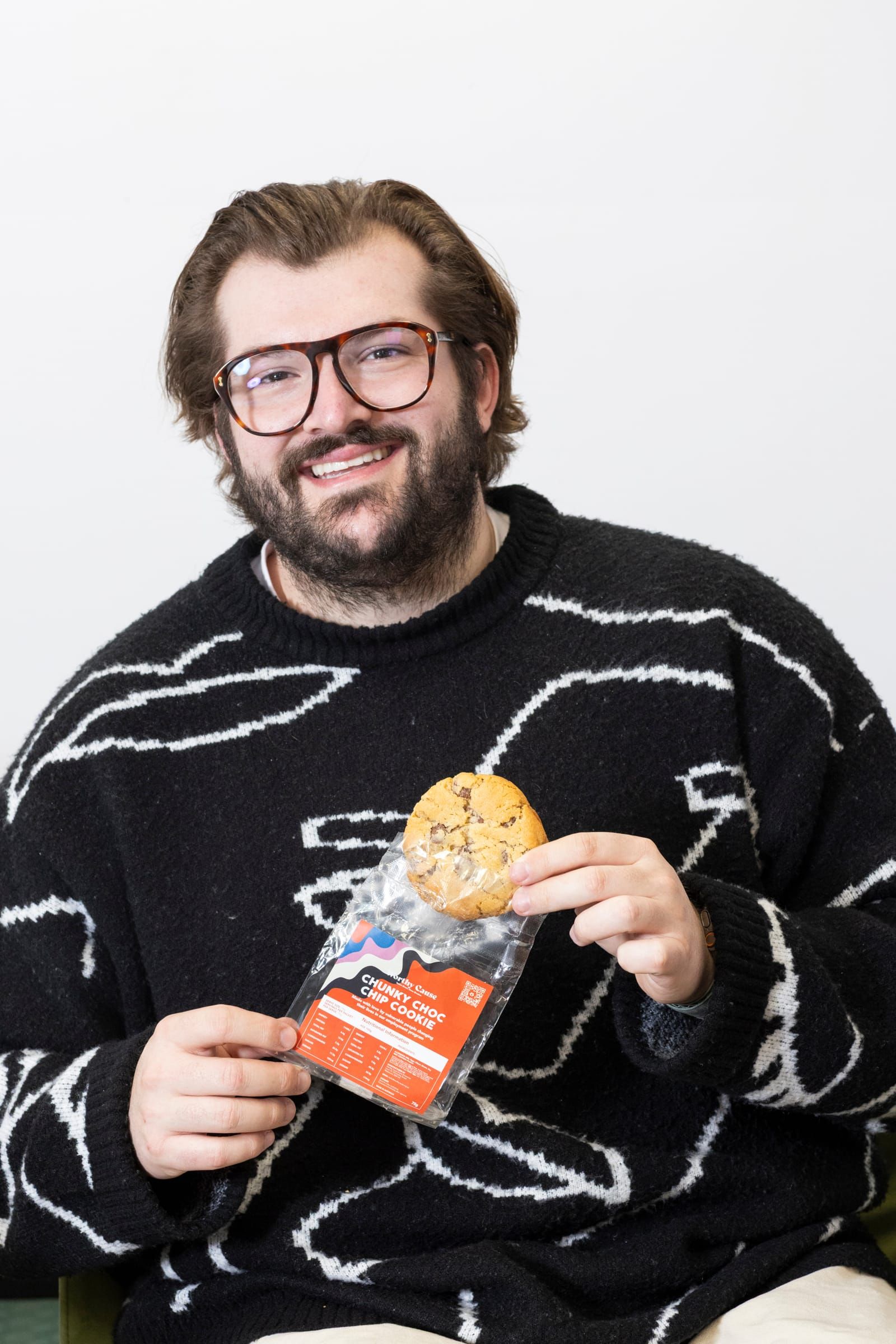 Rick Cohen holding a packaged Worthy Cause cookie