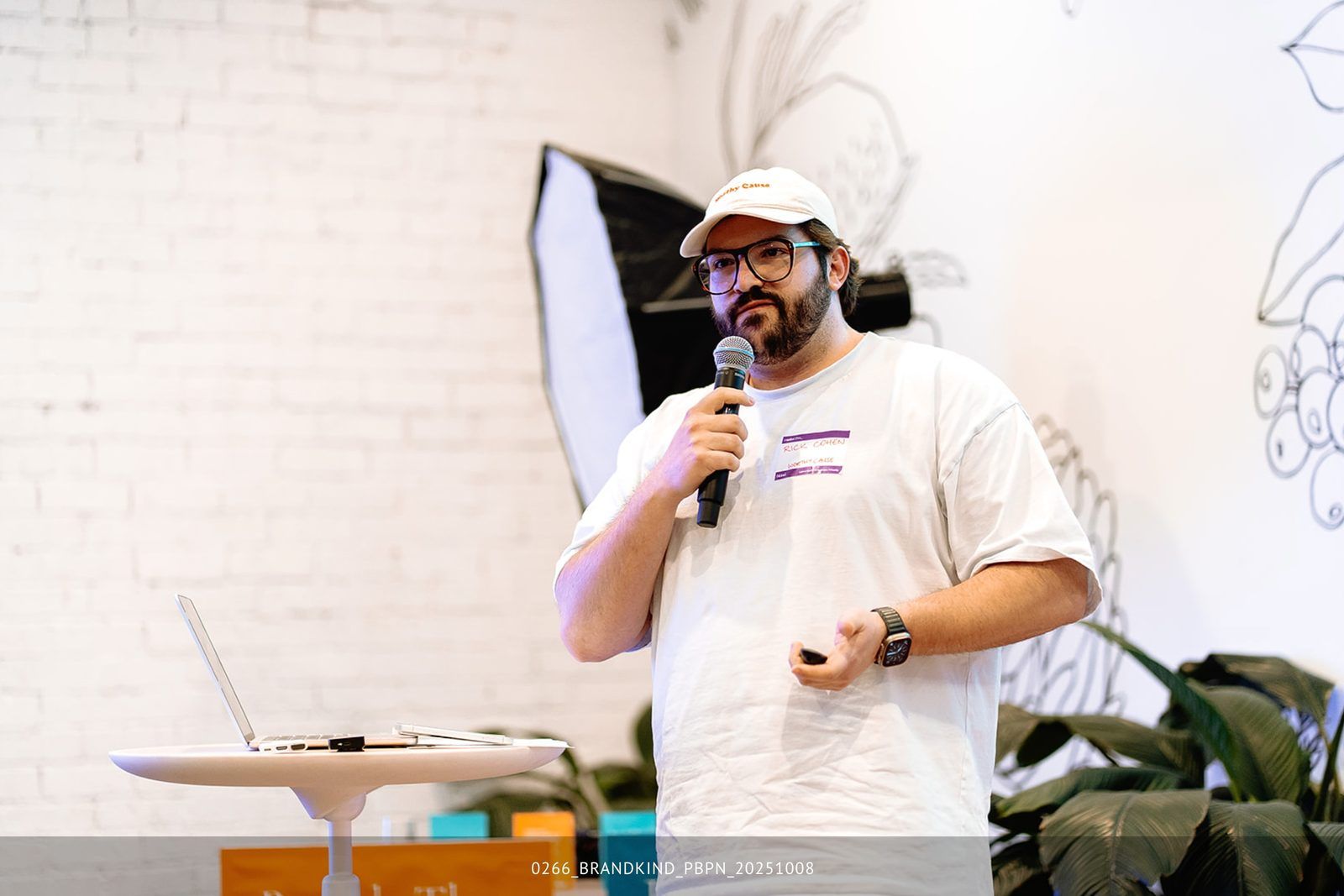 Rick Cohen presenting with a microphone at a community speaking event