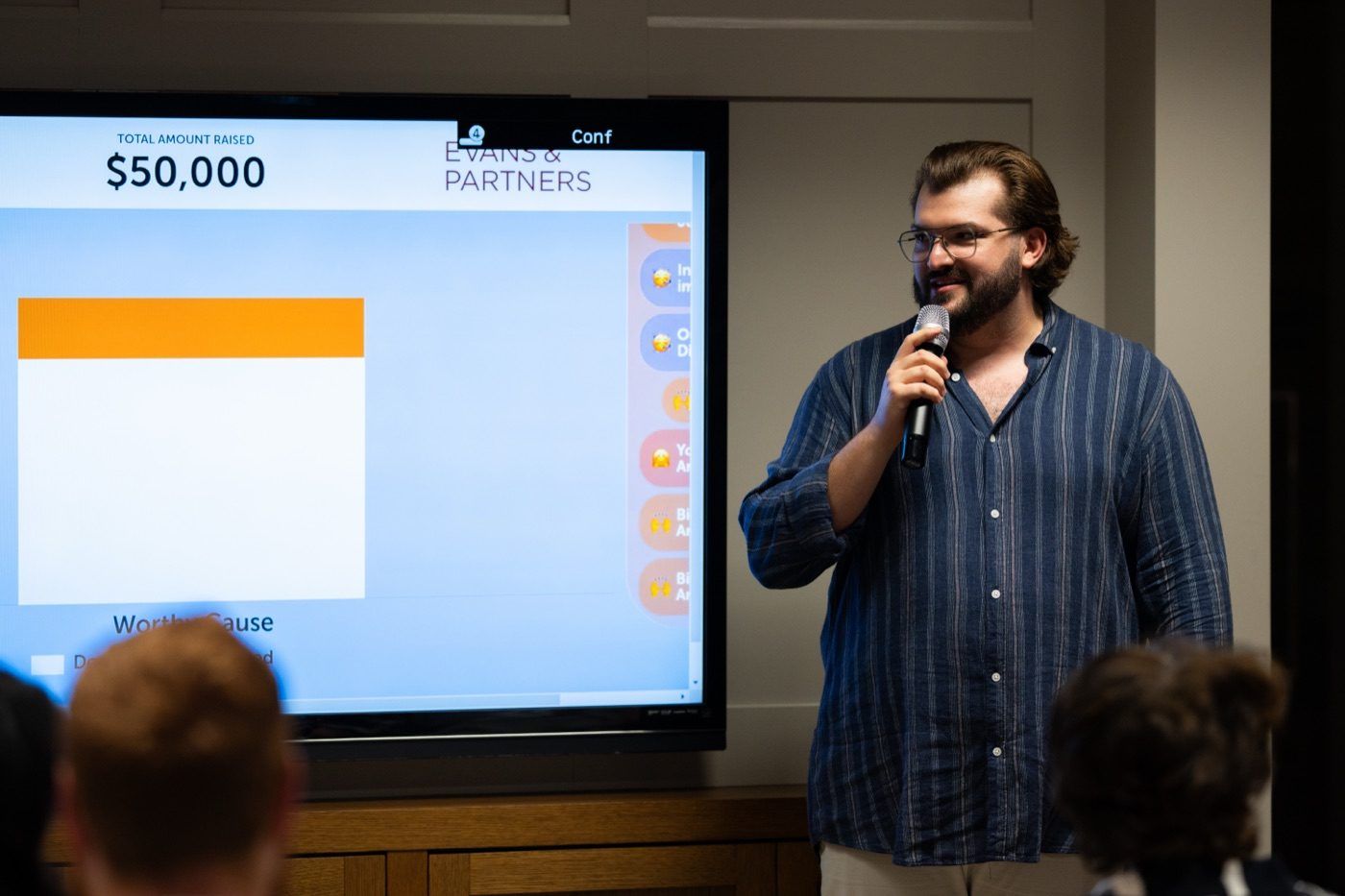 Rick Cohen presenting beside the Worthy Cause fundraising total on screen