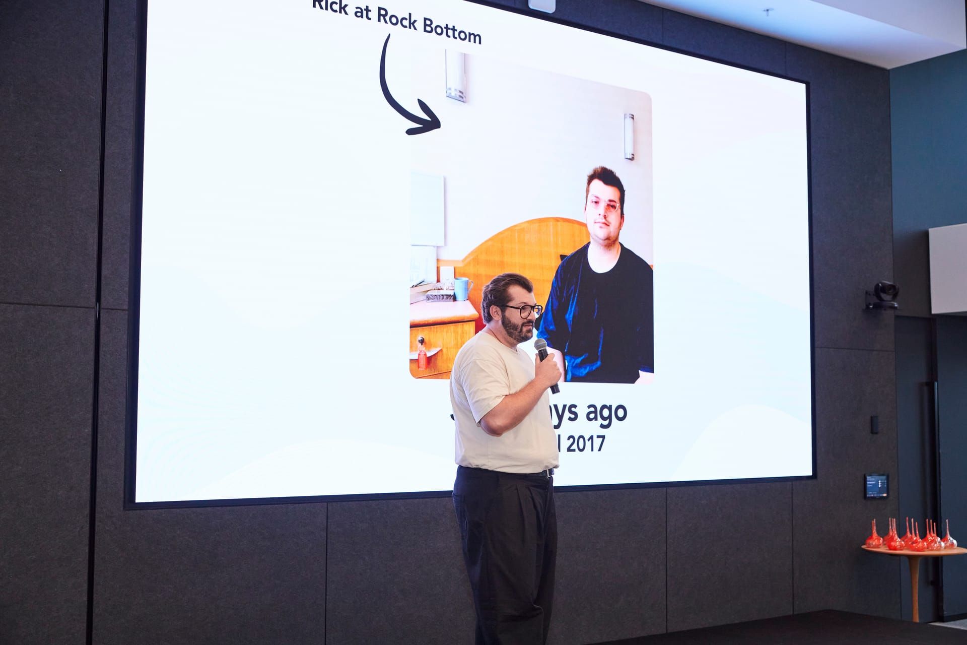 Rick Cohen on stage telling his origin story to an audience